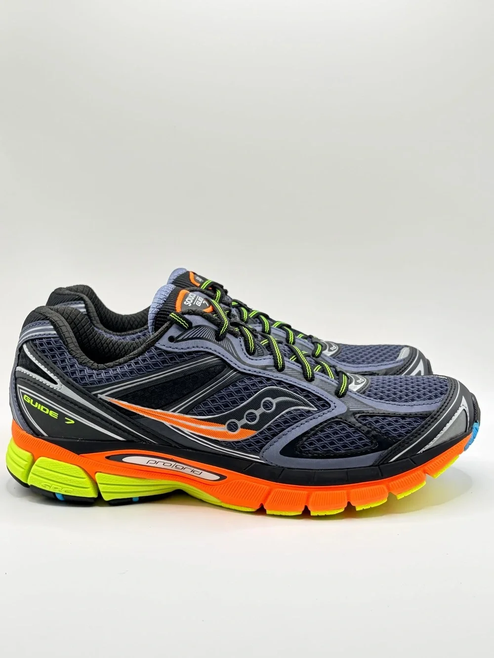 Saucony navy running shoes with orange & neon yellow accents